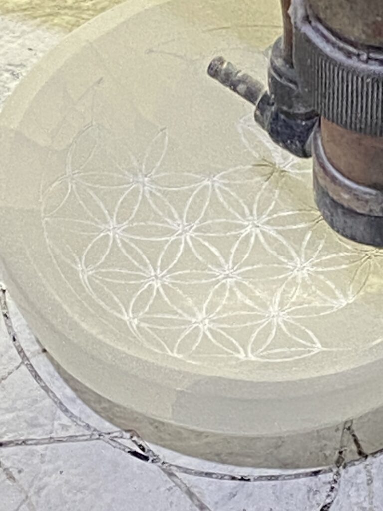 How We Travel the World to Source Our Crystals - Morocco 2024 10 Artisan engraving intricate patterns into selenite at a Moroccan factory