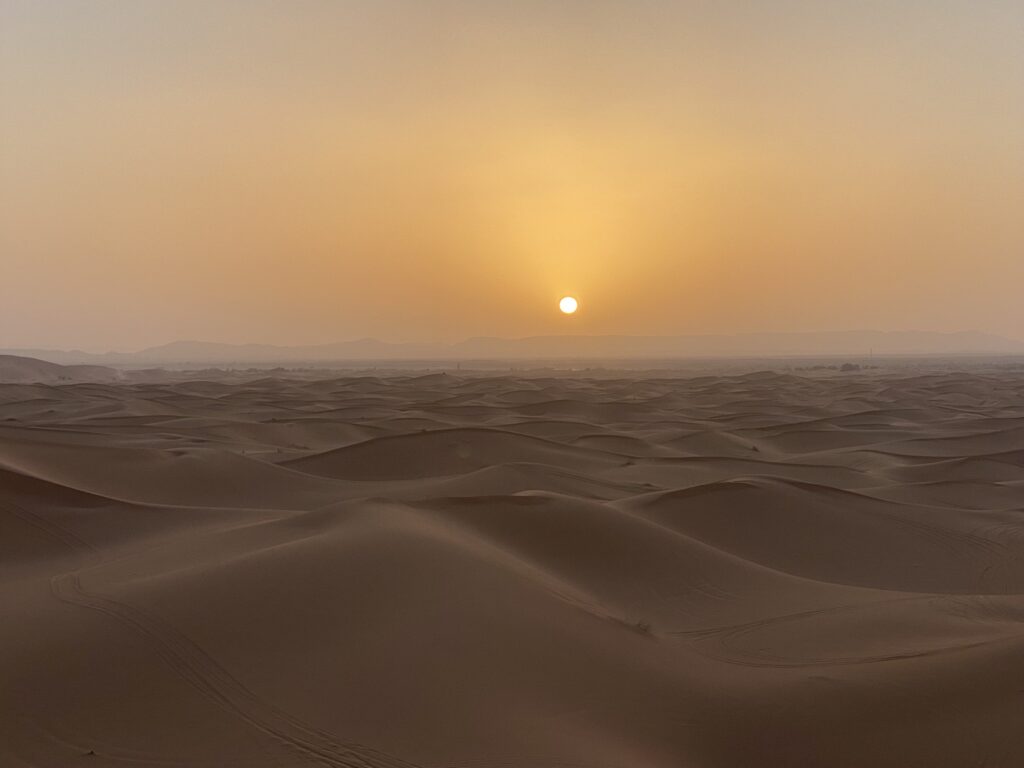 How We Travel the World to Source Our Crystals - Morocco 2024 19 Sunset over the Sahara Desert with warm golden light across the dunes