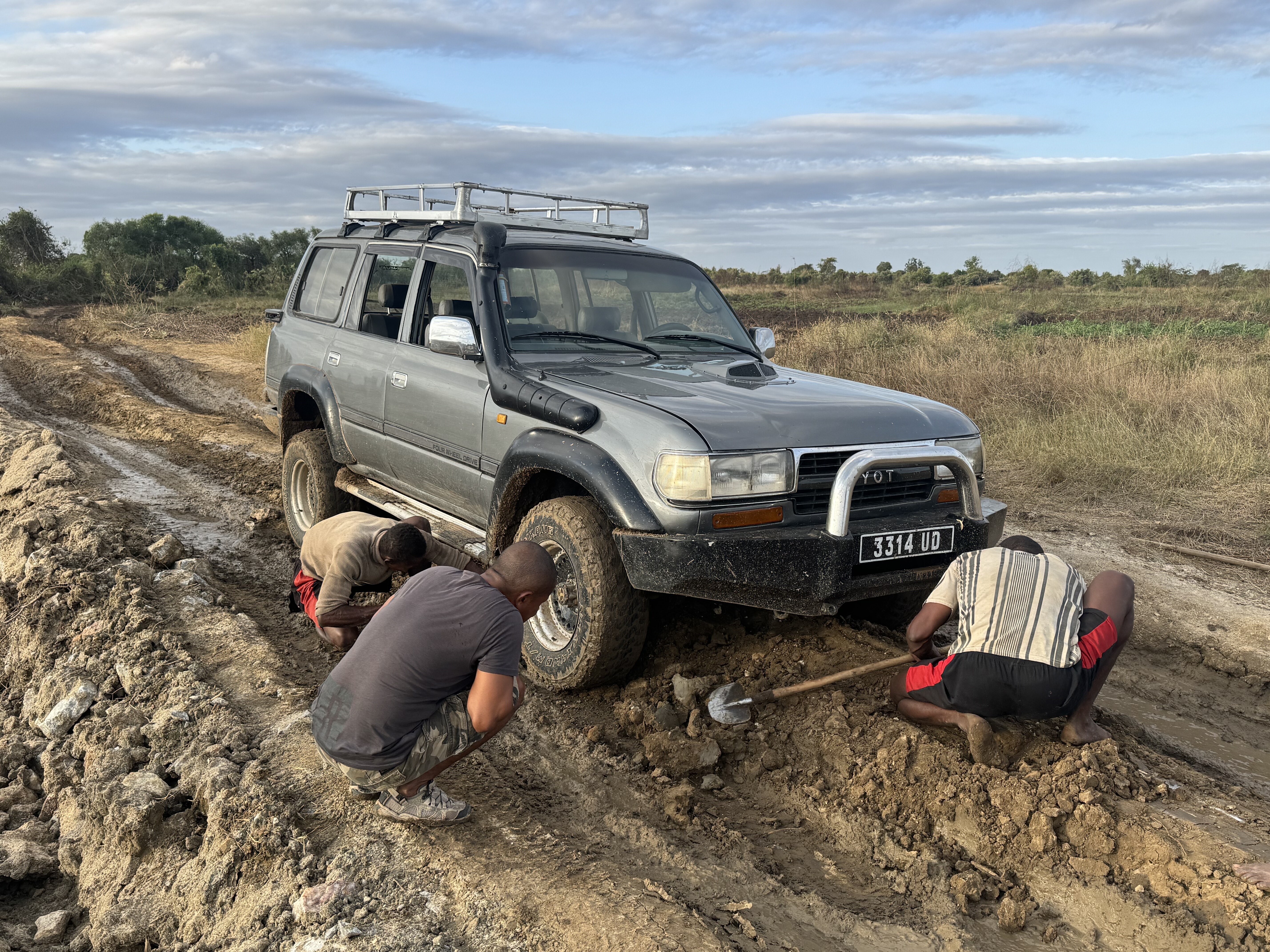 How We Travel the World to Source Our Crystals – Madagascar 2026 6 4WD vehicle stuck in muddy road during 14-hour journey to labradorite mine in Madagascar